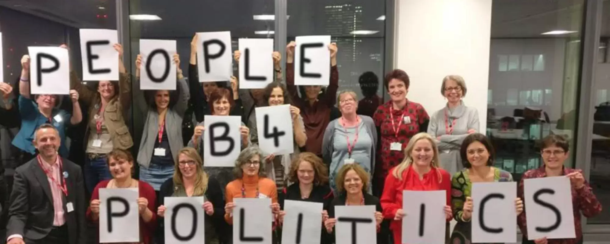 A group of people holding letters saying "People b4 politics"