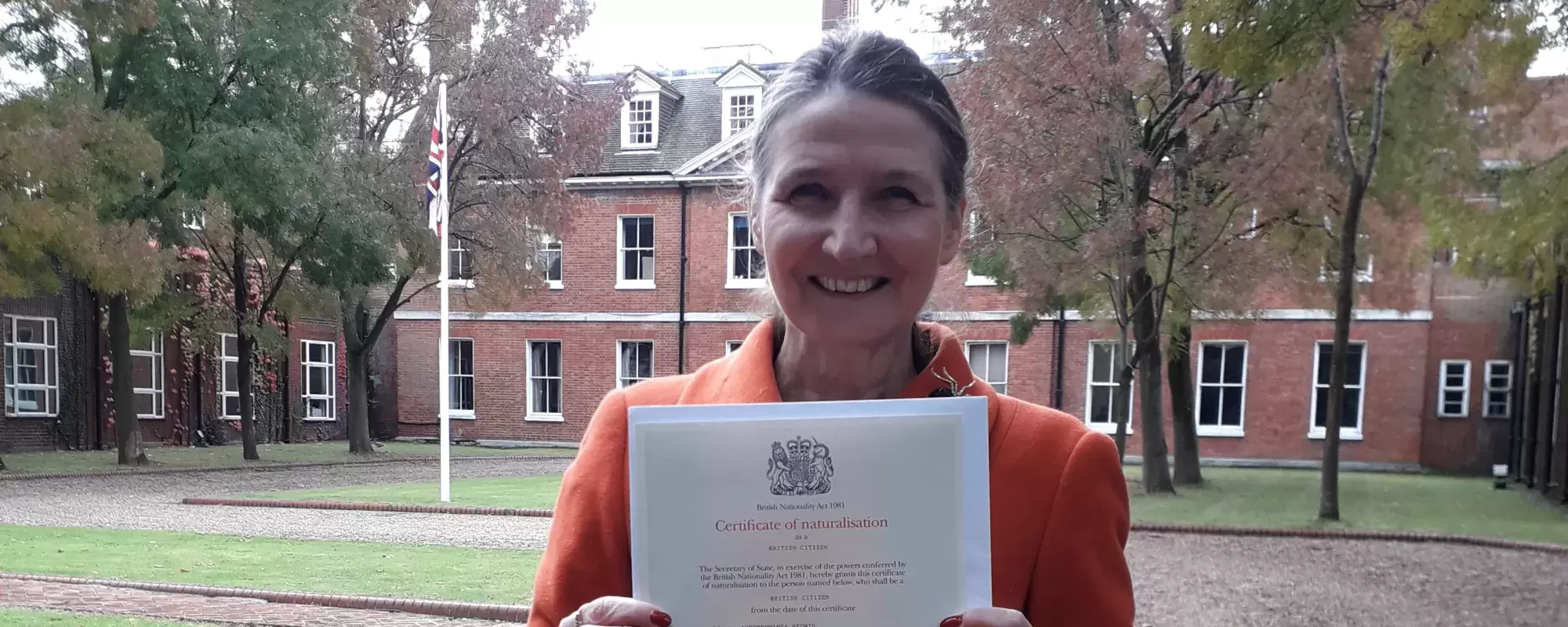 Hedwig - campaigner posing with her British citizenship certificate