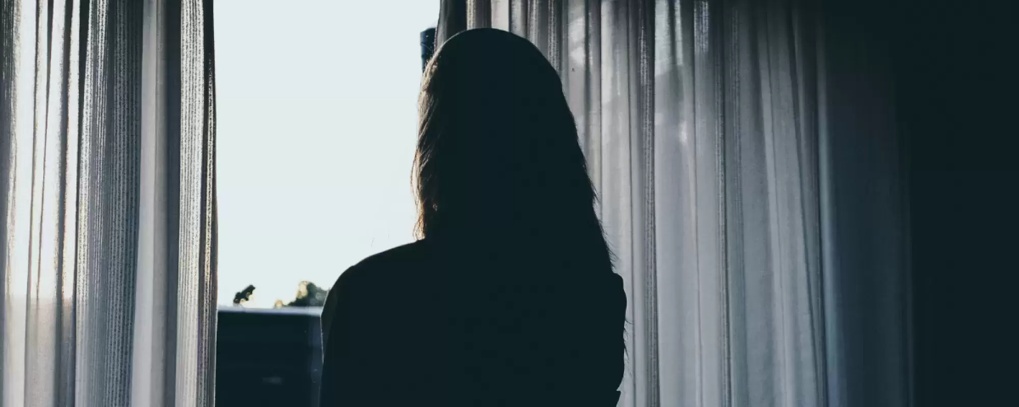 Woman in front of window