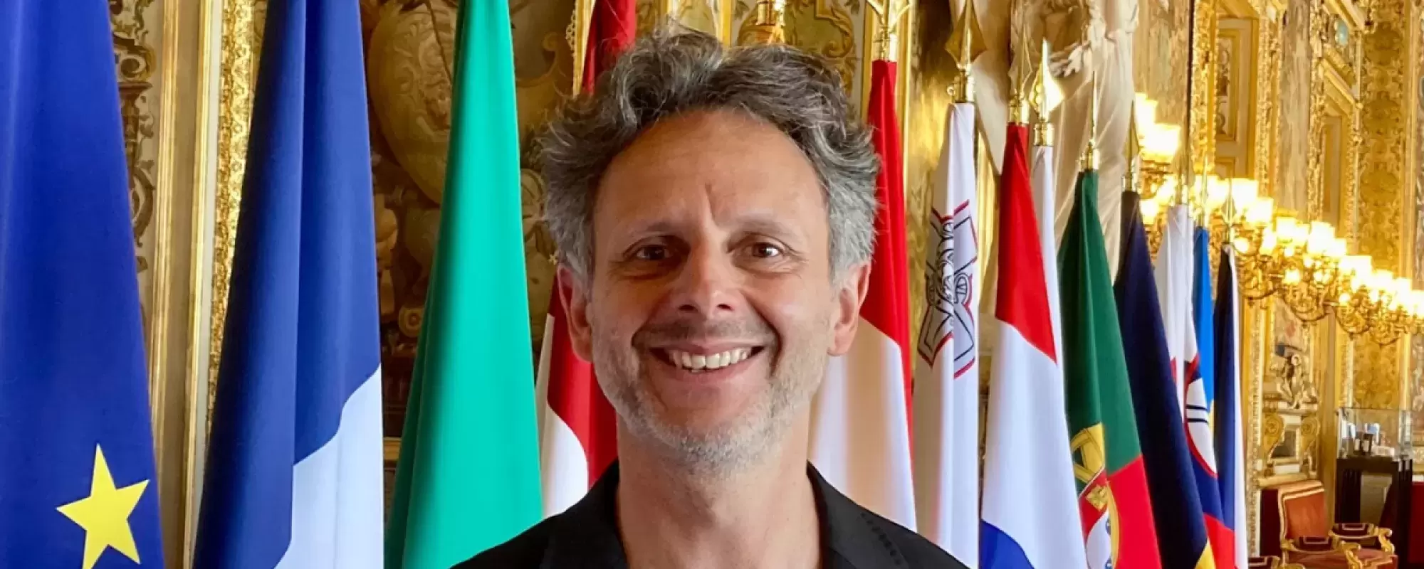 Nicolas Hatton in front of flags