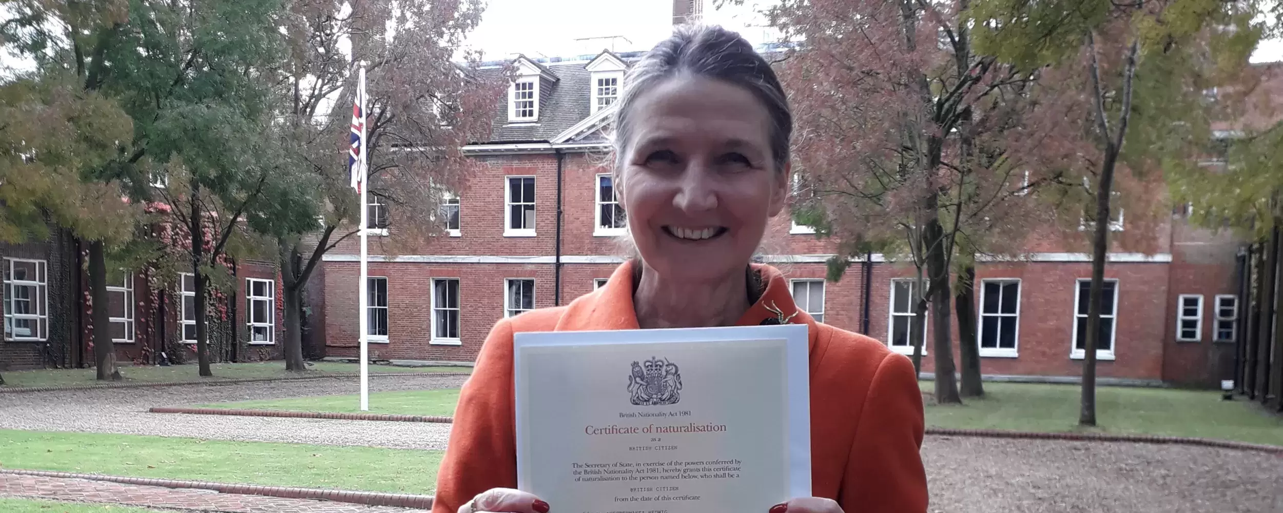 Hedwig - campaigner posing with her British citizenship certificate
