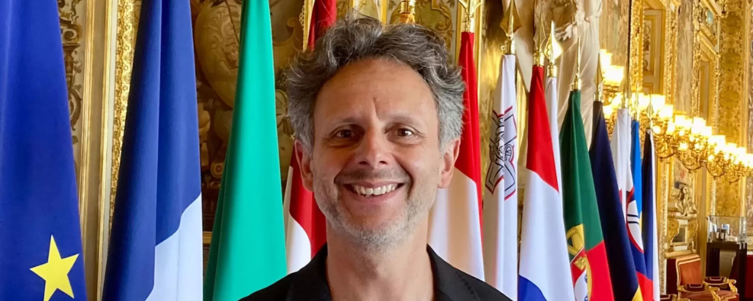 Nicolas Hatton in front of flags