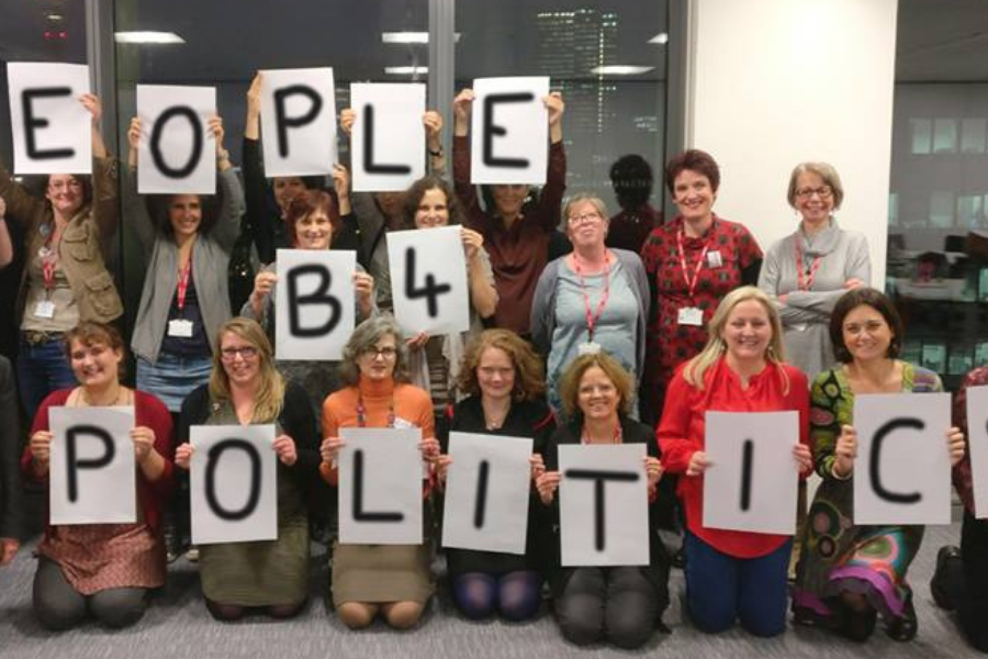 A group of people holding letters saying "People b4 politics"