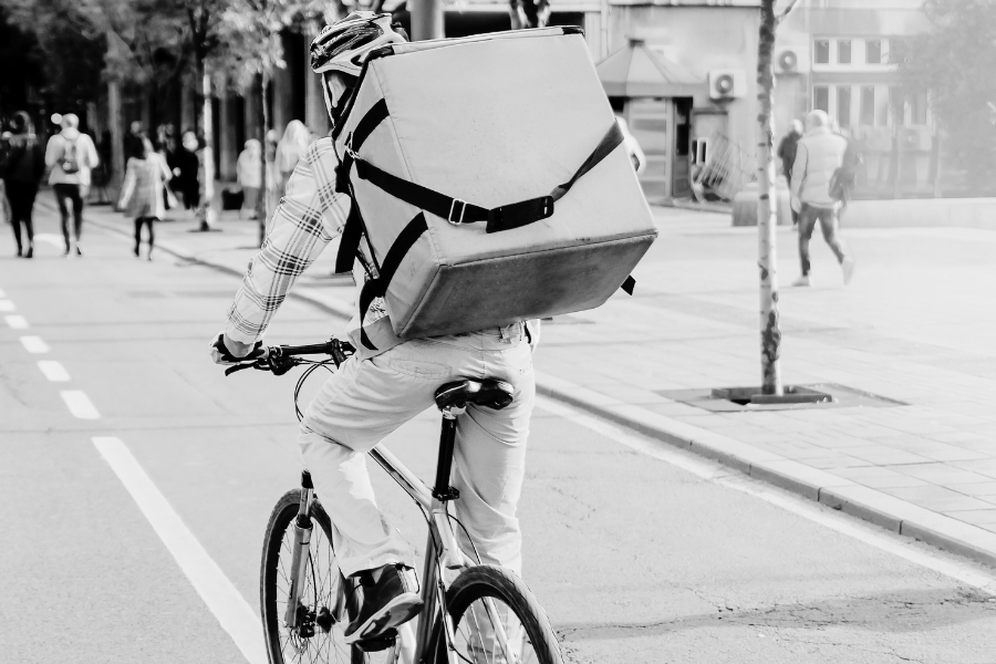 man making a delivery on a bicycle